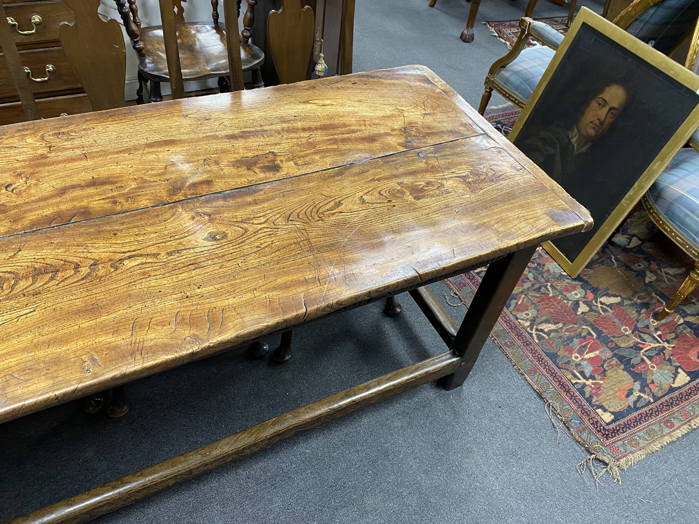 A late 17th / early 18th century elm two plank top refectory table (re-cleated), length 186cm, depth 70cm, height 76cm